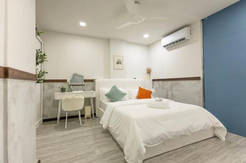 a bedroom with a white bed and a desk at Cozy 1BHK Apartment in Central Malé in Male City