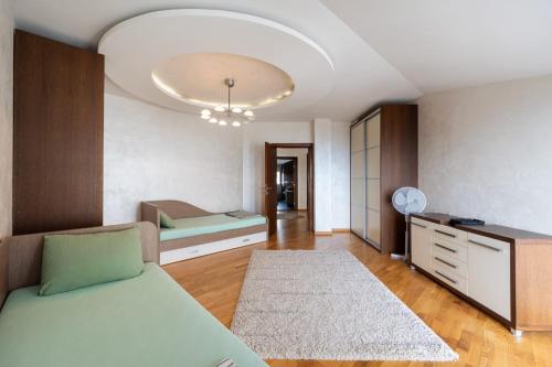 a bedroom with a bed and a dresser and a couch at Lux Apartment "Lea" in Kotor