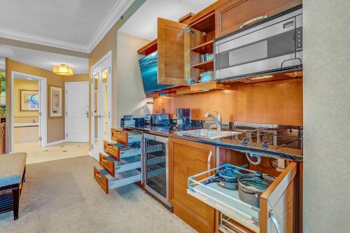 a kitchen with wooden cabinets and a sink at MGM Signature Tower 2 8th Floor 2-Suite Strip View Balcony No Resort Fee in Las Vegas