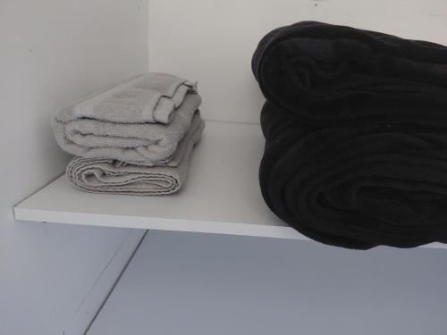 a pile of towels sitting on a shelf in a bathroom at San antero hospedaje in San Antero