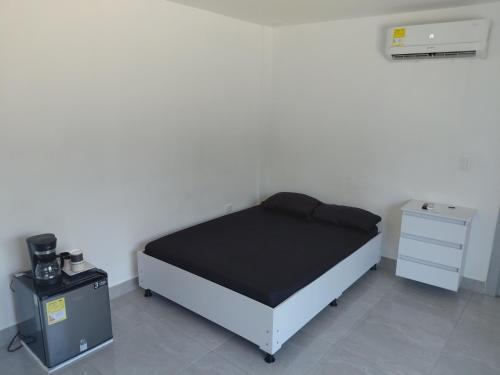a small bedroom with a bed and a dresser at San antero hospedaje in San Antero
