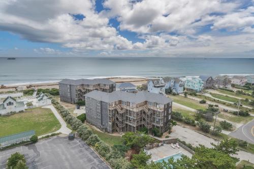 an aerial view of a building next to the ocean at 7662 - Sea La Vie in Avon
