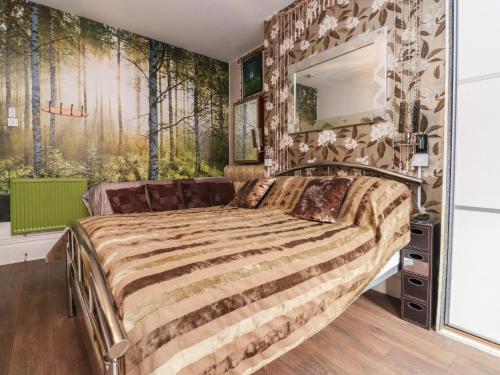 a bedroom with a large bed with a stone wall at Number 3 in Blackpool