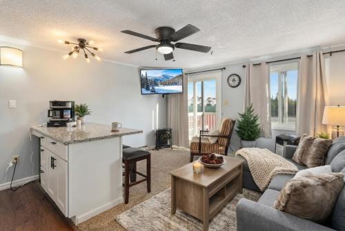 a living room with a couch and a table at Snowshoe Ski-InSki-Out Steps to Ballhooter Lift Mountain Lodge Condo in Snowshoe