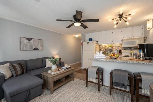 a living room with a couch and a kitchen at Snowshoe Ski-InSki-Out Steps to Ballhooter Lift Mountain Lodge Condo in Snowshoe