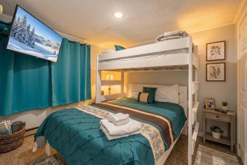 a bedroom with a bunk bed and a tv at Snowshoe Ski-InSki-Out Steps to Ballhooter Lift Mountain Lodge Condo in Snowshoe