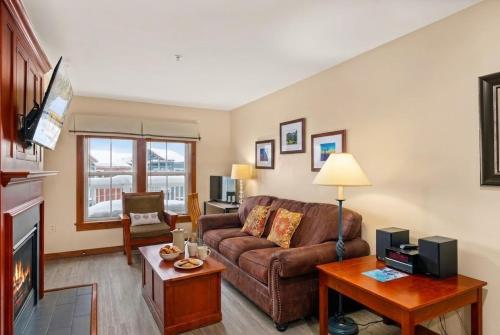 a living room with a couch and a table at No Resort Fee Ski-InOut Hot Tub Pool View Balcony Sleeps 4 in Snowshoe