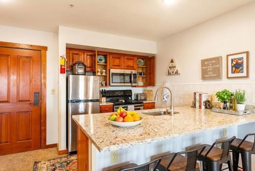 a kitchen with a bowl of fruit on a counter at HH207 Ski-inSki-out Condo Hot Tub Sleeps 4 in Snowshoe