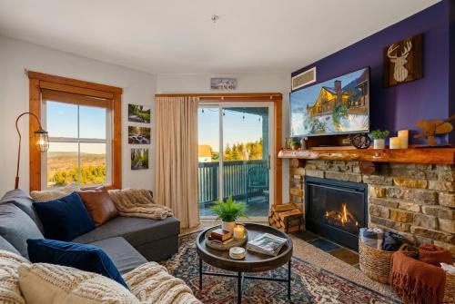 a living room with a couch and a fireplace at HH207 Ski-inSki-out Condo Hot Tub Sleeps 4 in Snowshoe