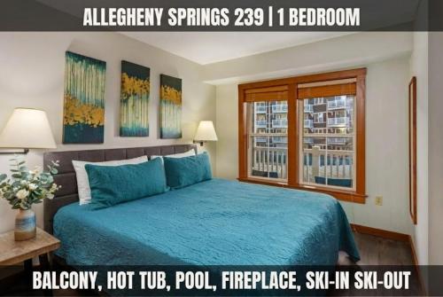a bedroom with a blue bed and a window at Lux Stay USA Pool view PanoramaSki-inOutHot Tub AS239 in Snowshoe