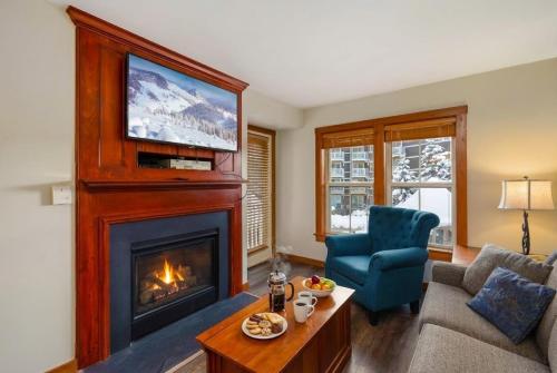 a living room with a fireplace and a tv at Lux Stay USA Pool view PanoramaSki-inOutHot Tub AS239 in Snowshoe