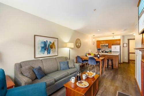 a living room with a couch and a table at Lux Stay USA Pool view PanoramaSki-inOutHot Tub AS239 in Snowshoe