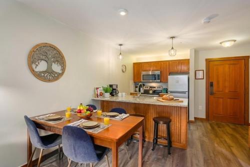 a kitchen with a wooden table and a dining room at Lux Stay USA Pool view PanoramaSki-inOutHot Tub AS239 in Snowshoe
