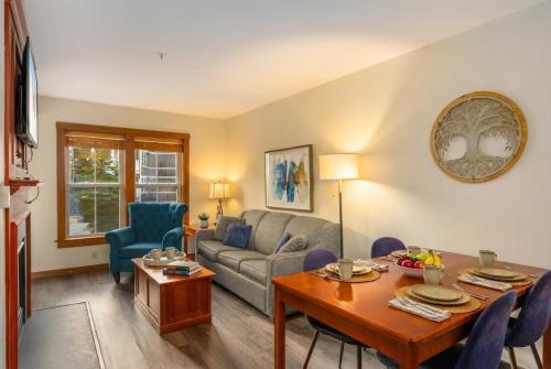 a living room with a couch and a table at Lux Stay USA Pool view PanoramaSki-inOutHot Tub AS239 in Snowshoe