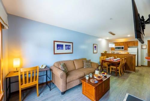 a living room with a couch and a table at Lux Stay USA Pool view Crest Ski-inout Hot Tub AS241 in Snowshoe