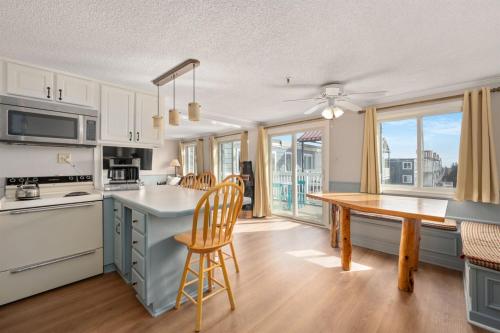 a kitchen with a table and chairs and a dining room at Snowshoe Ski-InSki-Out Steps to Ballhooter Lift Mountain Lodge Condo in Snowshoe