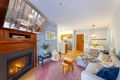 a living room with a couch and a fireplace at Lux Stay USA Pool view Hearthstone Ski-inOut, AS125 1BRDen in Snowshoe