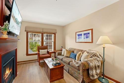 a living room with a couch and a fireplace at Lux Stay USA Pool view Serenity Ski inout Hot Tub AS 339 in Snowshoe