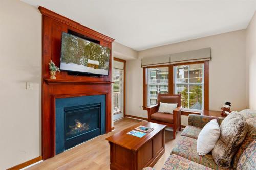 a living room with a fireplace and a tv at Lux Stay USA Pool view Serenity Ski inout Hot Tub AS 339 in Snowshoe