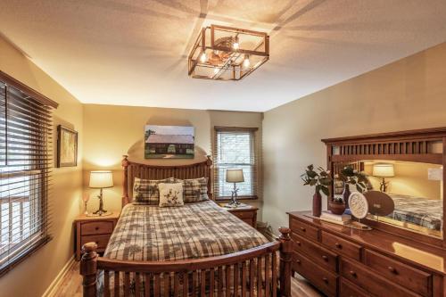a bedroom with two beds and two windows at Nestled Inn in Townsend