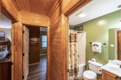 a bathroom with a toilet and a sink at Nestled Inn in Townsend