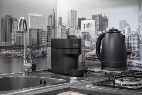 a kitchen counter with a coffee maker on a sink at Appartamento Elegante con 2 Camere nel Centro Storico di Bologna in Bologna