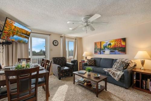 a living room with a couch and a table at Snowshoe Ski-InSki-Out Steps to Ballhooter Lift Mountain Lodge Condo in Snowshoe