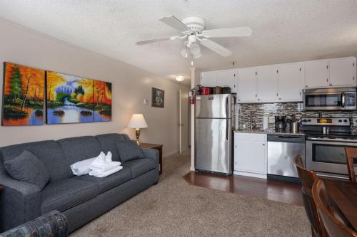 a living room with a couch and a kitchen at Snowshoe Ski-InSki-Out Steps to Ballhooter Lift Mountain Lodge Condo in Snowshoe