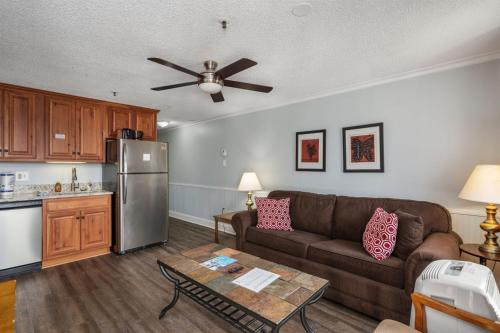 a living room with a couch and a kitchen at ML 345 Ski-InOut Slope Views Sleeps 6 Steps to Ballhooter in Snowshoe