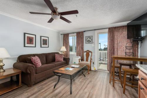 a living room with a couch and a table at ML 345 Ski-InOut Slope Views Sleeps 6 Steps to Ballhooter in Snowshoe