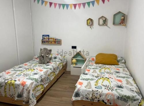 a bedroom with a bed with a teddy bear on it at Chalet Las Meninas in Denia