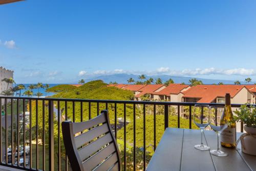 a table and chairs on a balcony with a view at Kaanapali Shores 640 in Kahana