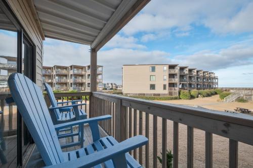two chairs on a balcony with a view of the beach at 2971 - Seabbatical in Duck