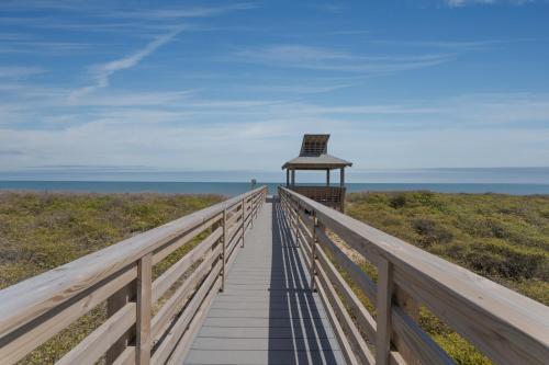 a boardwalk leading to a lifeguard tower on the beach at 2971 - Seabbatical in Duck