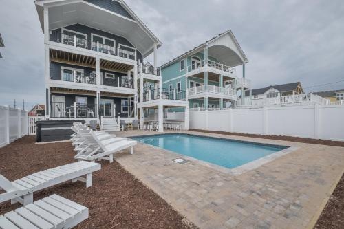 a house with a swimming pool next to a building at 5705 - Edgewater View in Nags Head
