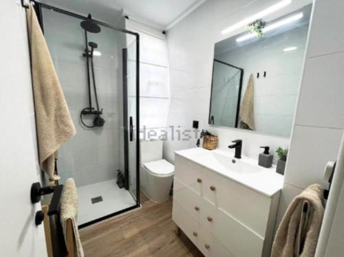 a bathroom with a shower and a sink and a toilet at Chalet Las Meninas in Denia