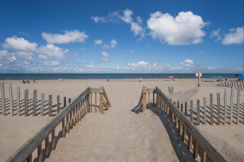 a sandy beach with a wooden boardwalk and the ocean at 7081 - Sea View in Rodanthe