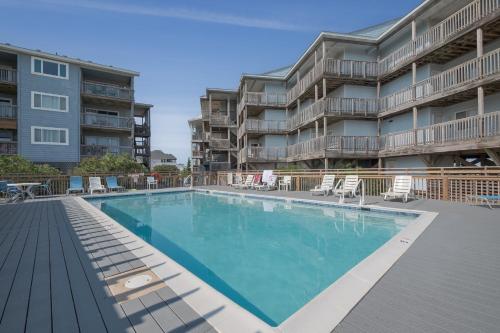 a swimming pool in front of a apartment building at 7081 - Sea View in Rodanthe
