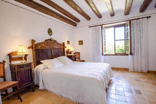 a bedroom with a large bed and a window at Catalunya Casas Unique sanctuary with extra large pool! in Santa Oliva