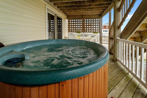 a hot tub on the deck of a house at 4744 - Sandy Beaches in Kitty Hawk Beach