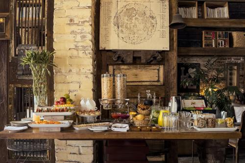 a table with a buffet of food on it at Alko Hotel Casa Nispero in Cali