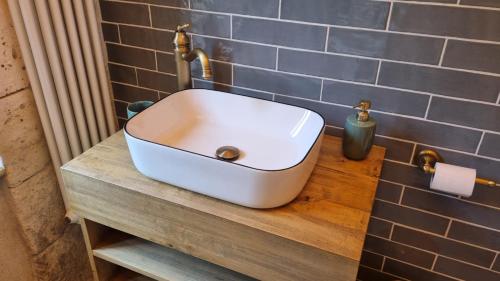 a white sink on a counter in a bathroom at La Chaumière in Salles-Lavalette