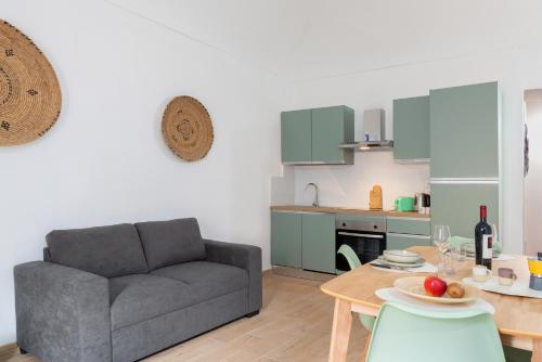 a living room with a couch and a table at Terra e Mare Apartments II- Terra in Sorso