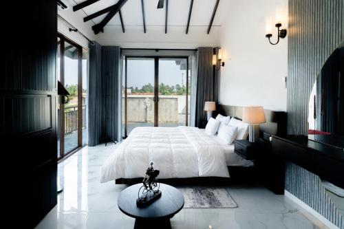 a bedroom with a large bed and a large window at Peak Heaven Apartments in Negombo