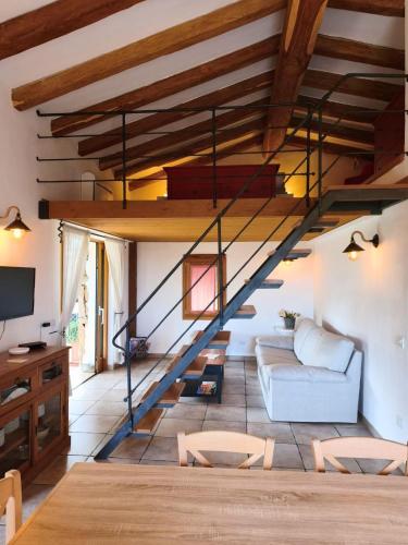 a living room with a staircase in a house at Spartaco Eco Retreat San Pantaleo in San Pantaleo