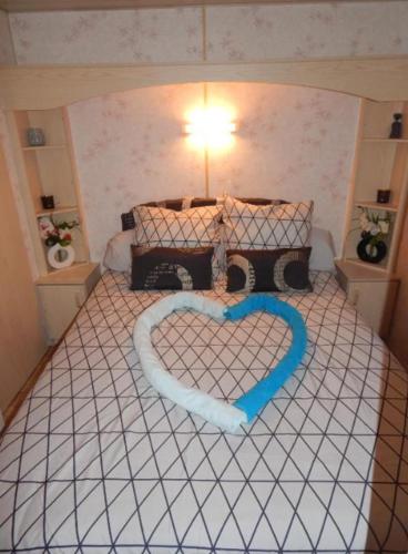 a bedroom with a bed with a heart on it at L'ancyze in Le Torp-Mesnil