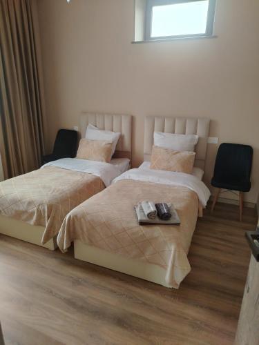 two beds in a hotel room with a tray on them at Elen Apartment Goris in Goris