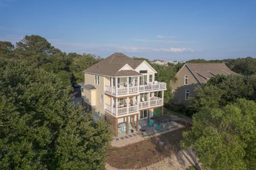 an aerial view of a large house in the trees at 1064 - Sunset Cottage in Corolla