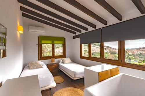 a living room with two beds and a couch at Villa My Love Mallorca in Bunyola