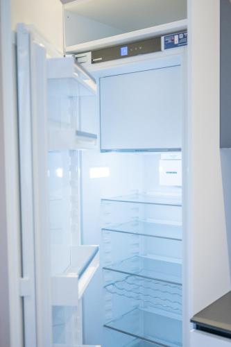 a refrigerator door is open in a kitchen at Appartament Lago di Braies in San Sigismondo
